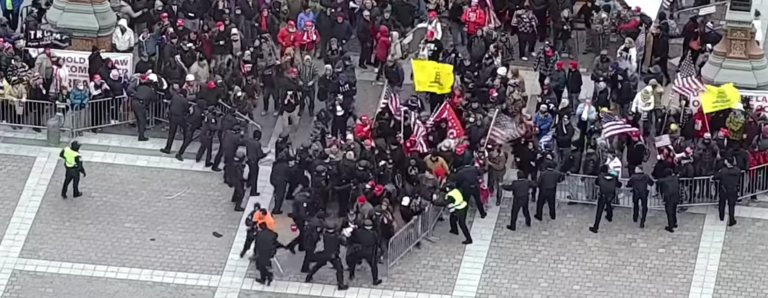 Rioters breaching the bike-rack line outside the Capitol on Jan. 6, 2021.