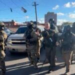 Border Patrol leader Greg Bovino tossing tear gas into a crowd of protesters last month. (Screen grab)