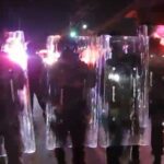 New Jersey state police form a phalanx with their riot shields and advance on protesters on May 30