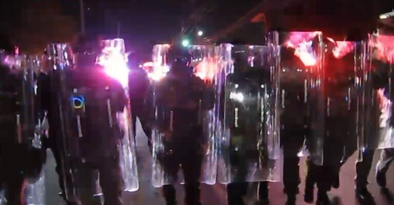 New Jersey state police form a phalanx with their riot shields and advance on protesters on May 30